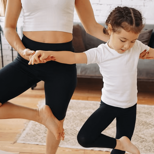 a woman and a child doing yoga