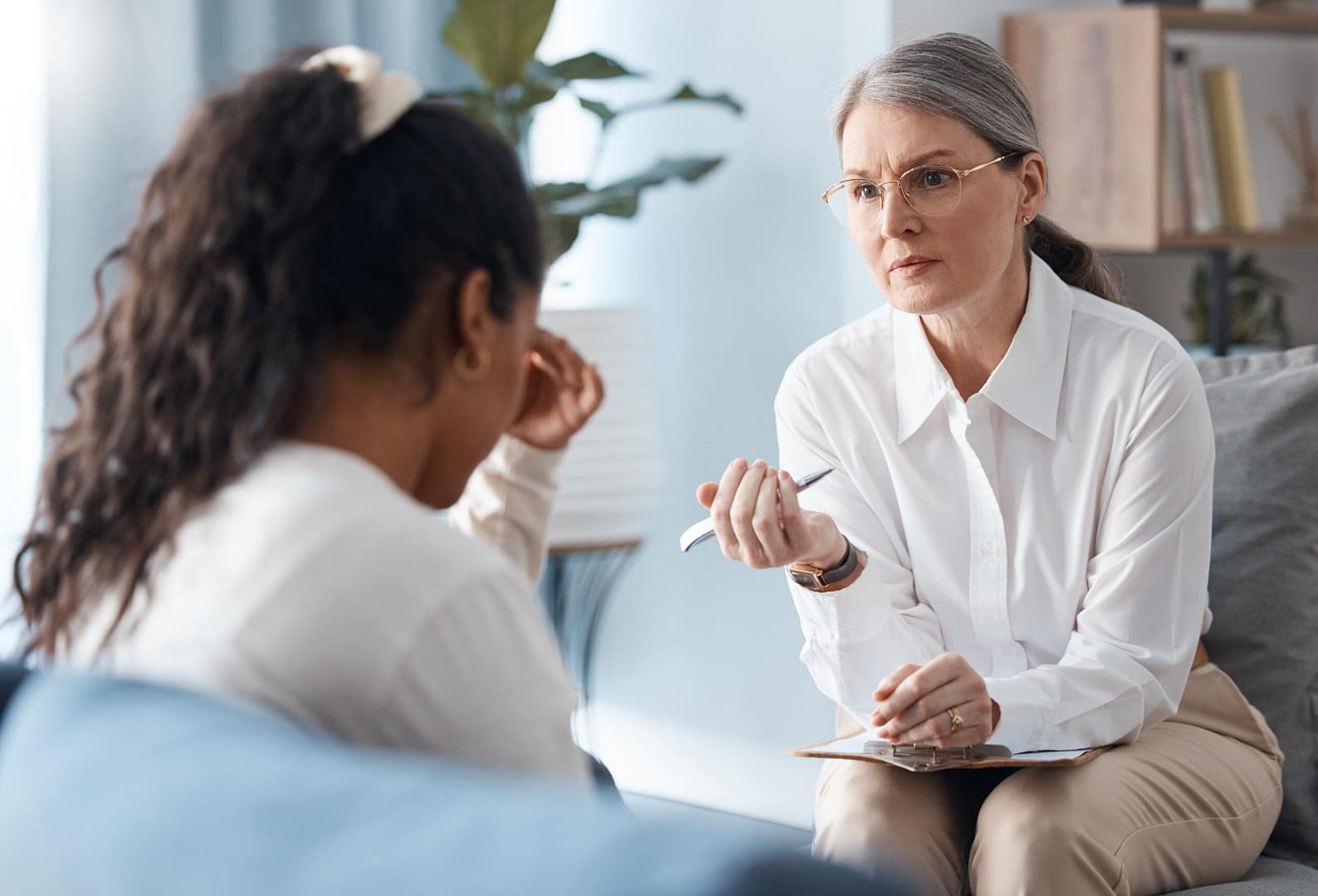Woman, therapist and consulting sad patient in counseling, mental health or psychology for healthcare. Female person or psychologist talking to client with anxiety or stress in therapy consultation.