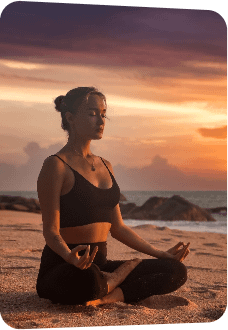 slim-woman-does-yoga-lotus-posture-tropical-sea-coast-ocean-beach-outdoors-sunset